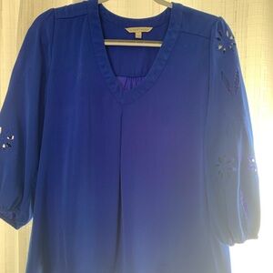 Beautiful blue blouse with accent cutouts on the sleeves.